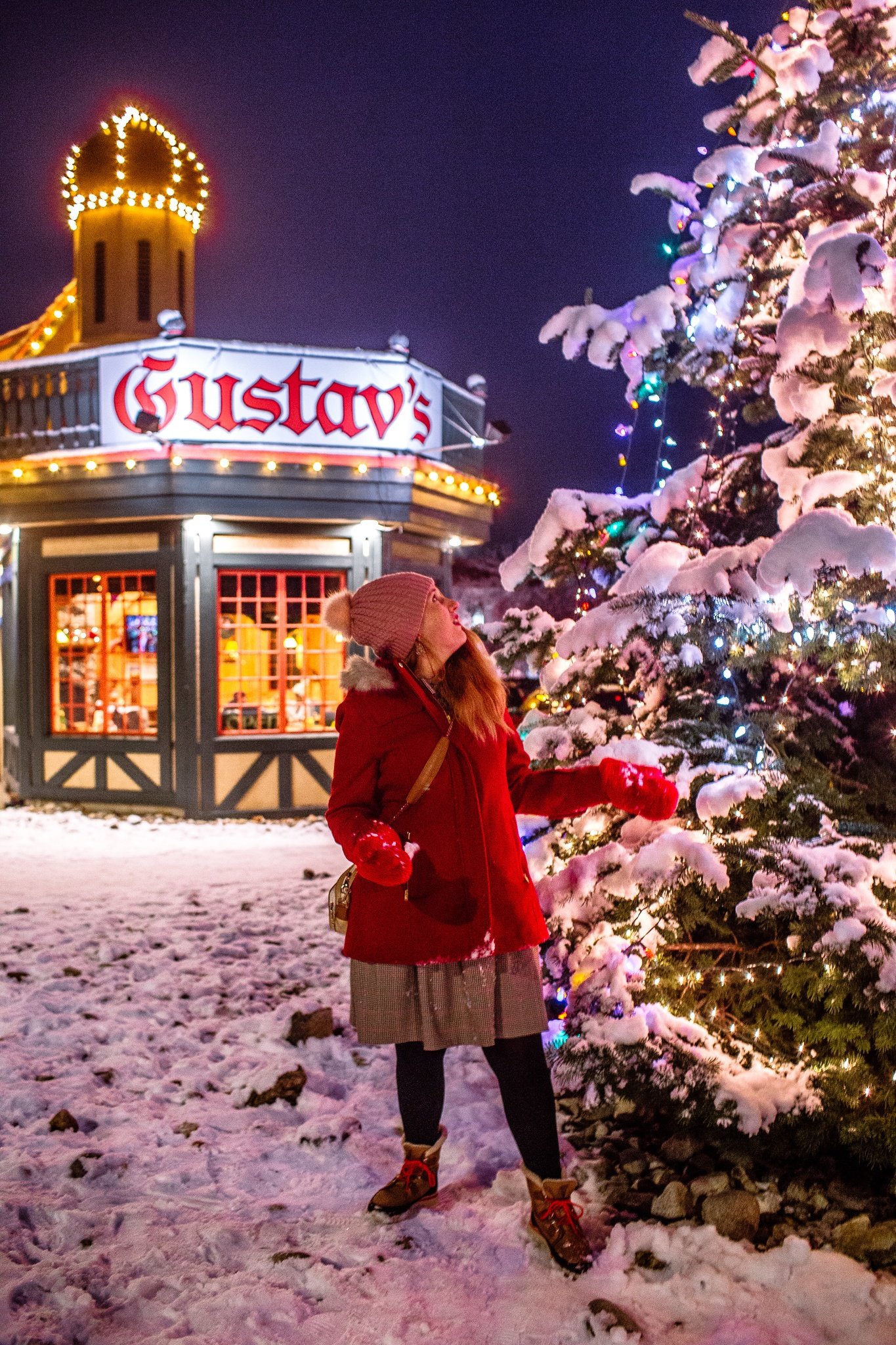 woman by christmas tree in front of gustav;s in leavenworth