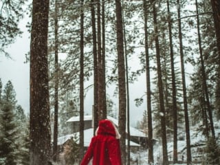 woman in red ensemble in the snowy pnw woods