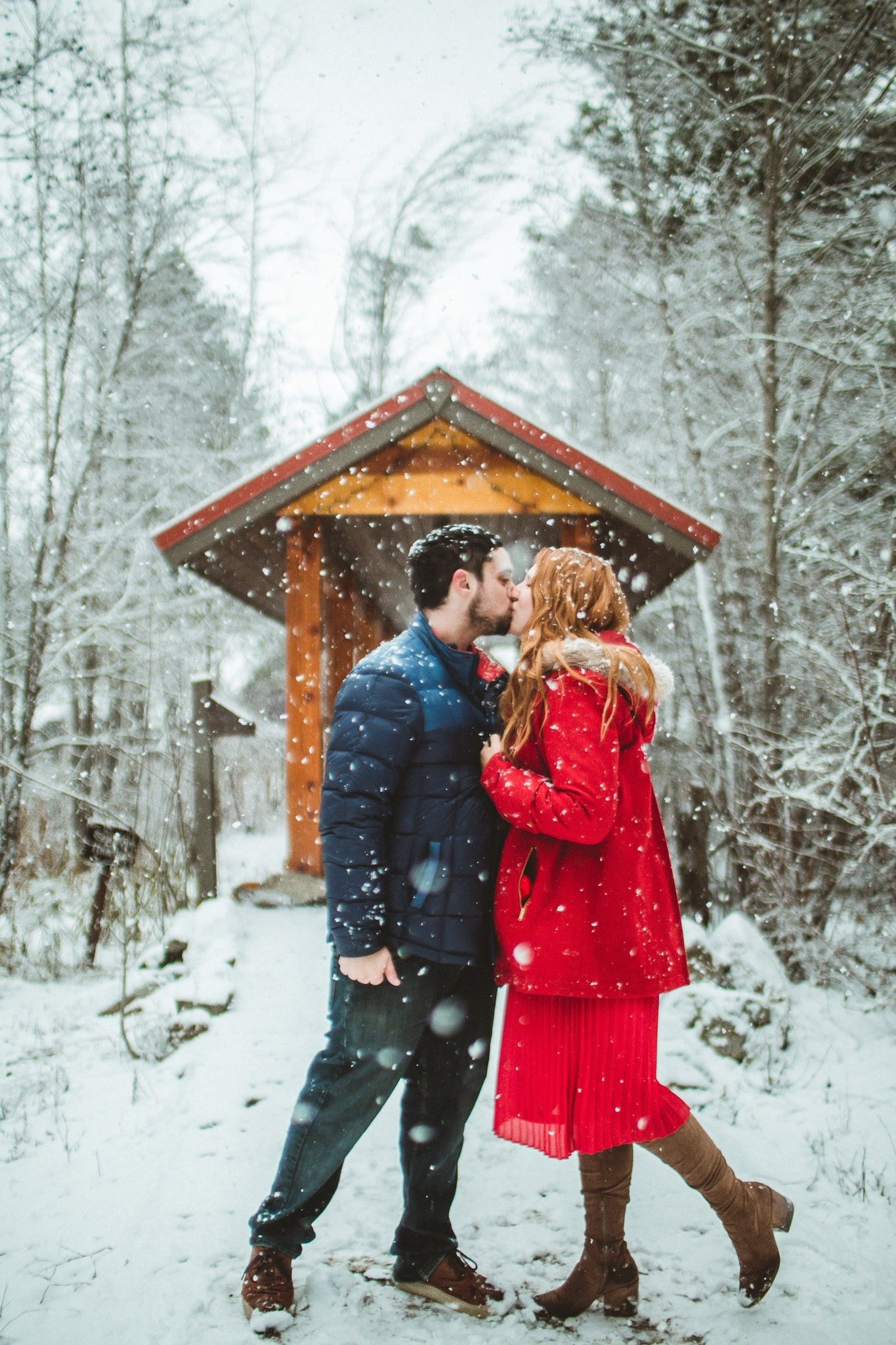 Man and Woman kissing in the snow at Sleeping Lady resort