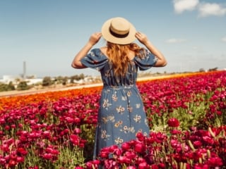 Wearing a blue floral pattern dress with a straw hat at the Carlsbad Flower Fields