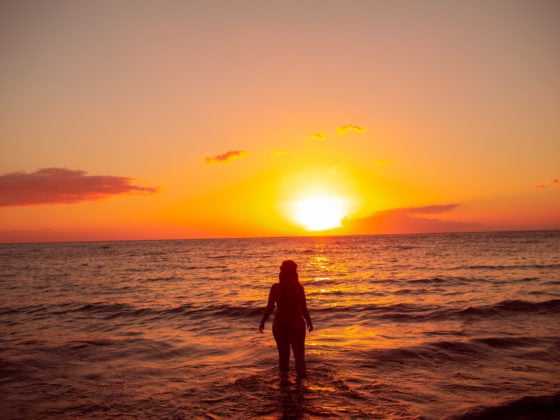 wearing my red swimsuit on Kiwakapu beach in maui