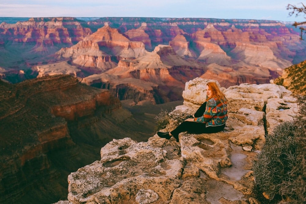 Kara of Whimsy Soul sitting on the edge of the Grand Canyon in Arizona